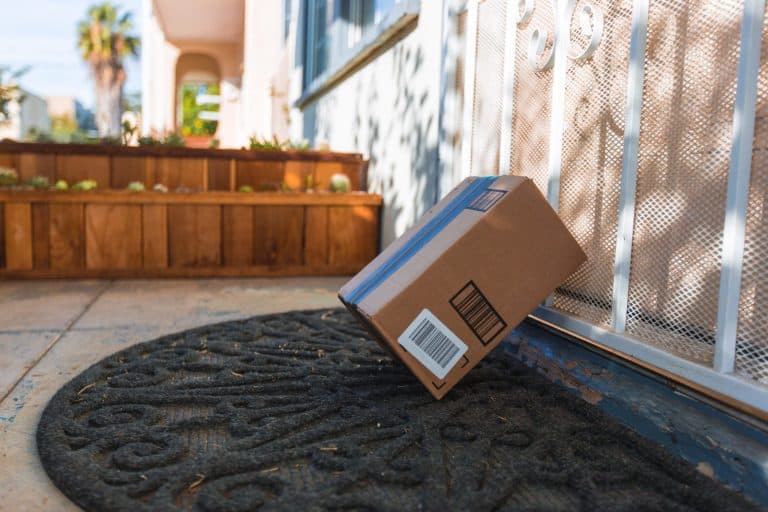 A parcel left in the front yard of a home leaned against the gate