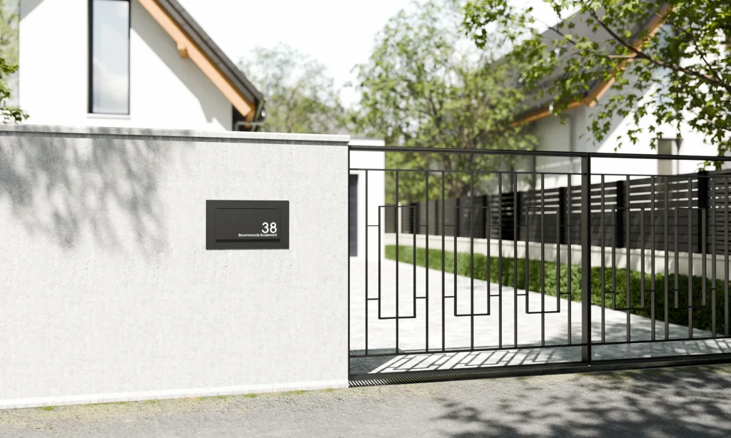 Modern built-in black letterbox on a contemporary front wall at the entrance of a UK home.